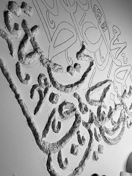 Decorative wall art with intricate patterns on a plain background