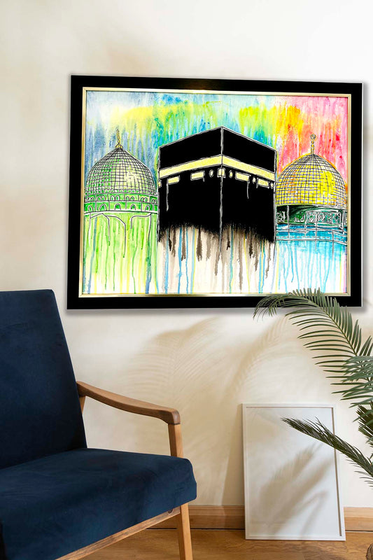 Framed artwork of a religious building with colorful abstract design on a wall above a blue chair.